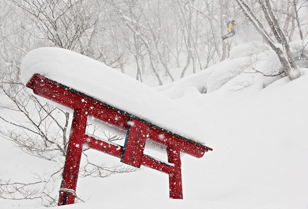 Stefan airs off a pillow near a snow covered shrine.