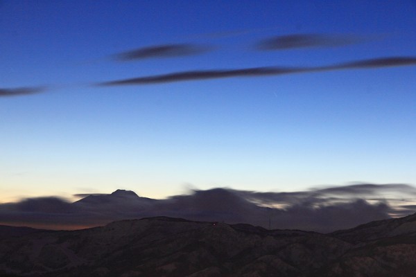 Clouds move over nearby mountains late yesterday evening.